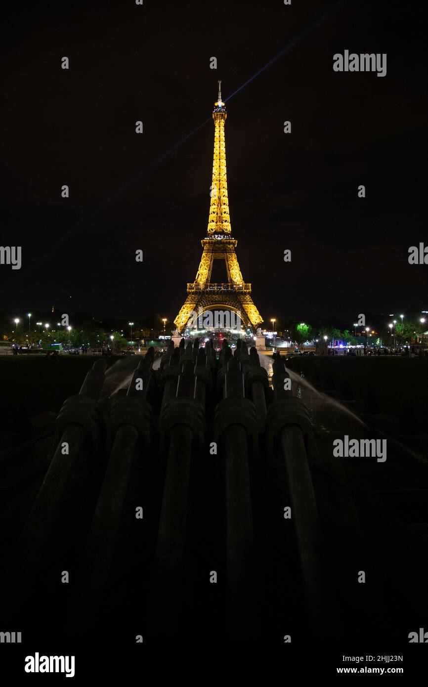 The eiffel tower lit up at night over looking the city. Stock Photo