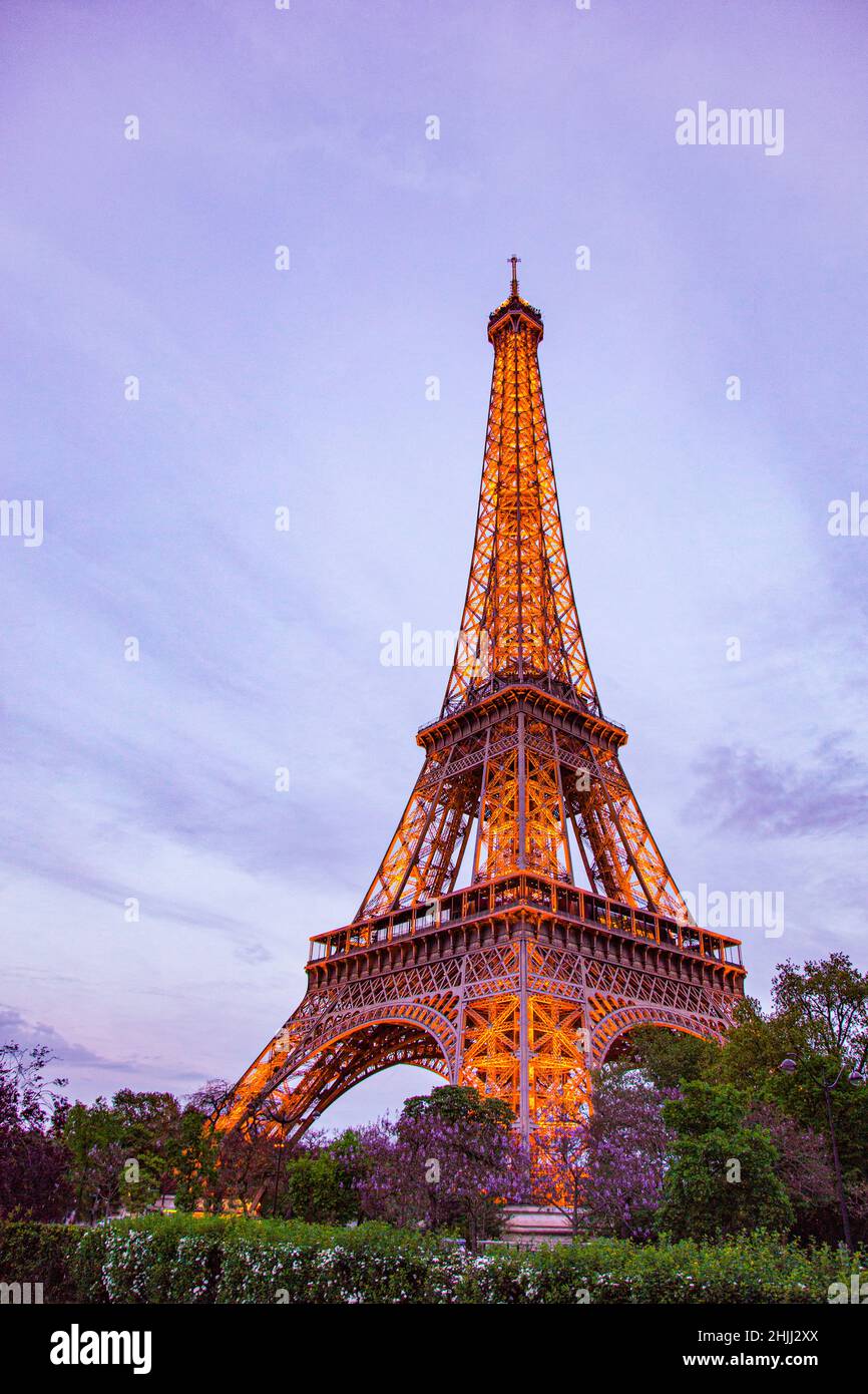 Lit up Eiffel Tower at Dusk in Paris. Stock Photo