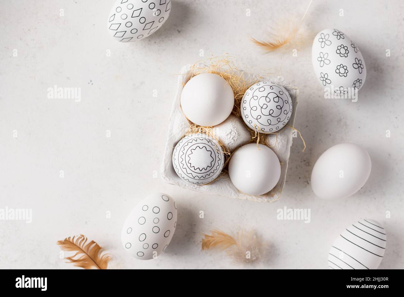 Easter eggs with black and white pattern and feathers Stock Photo