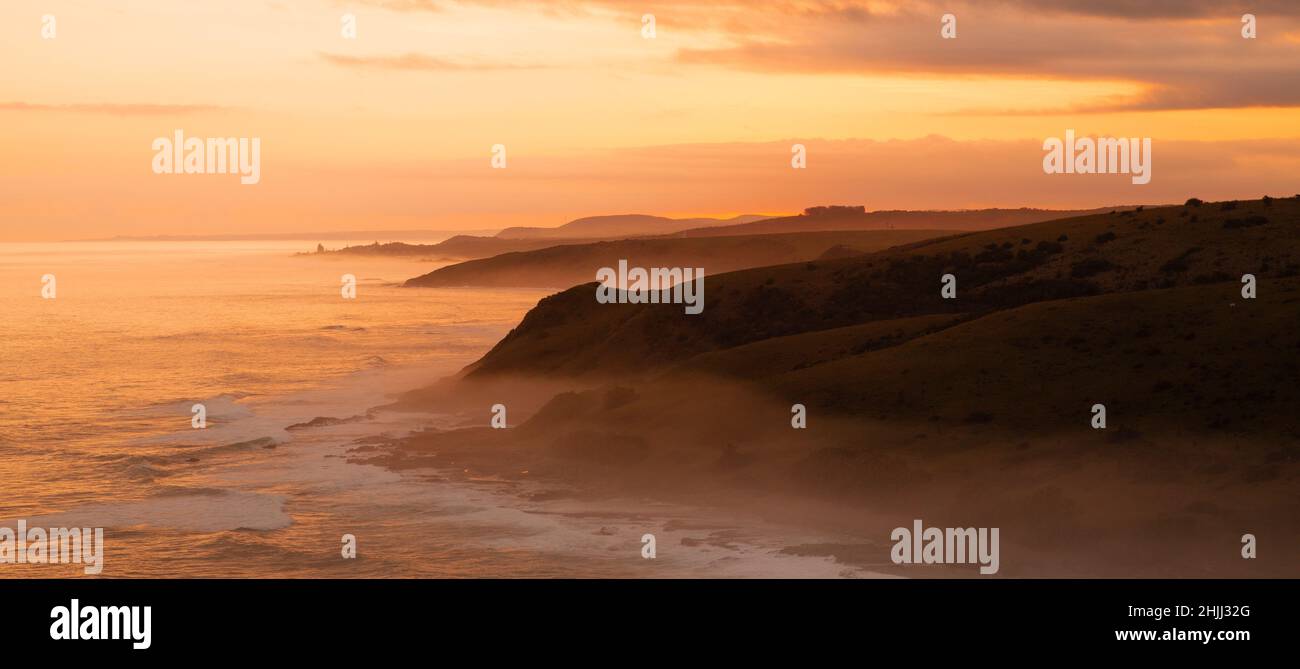 Morgan Bay Cliffs on the Wild Coast at a misty Dusky Sunset Stock Photo