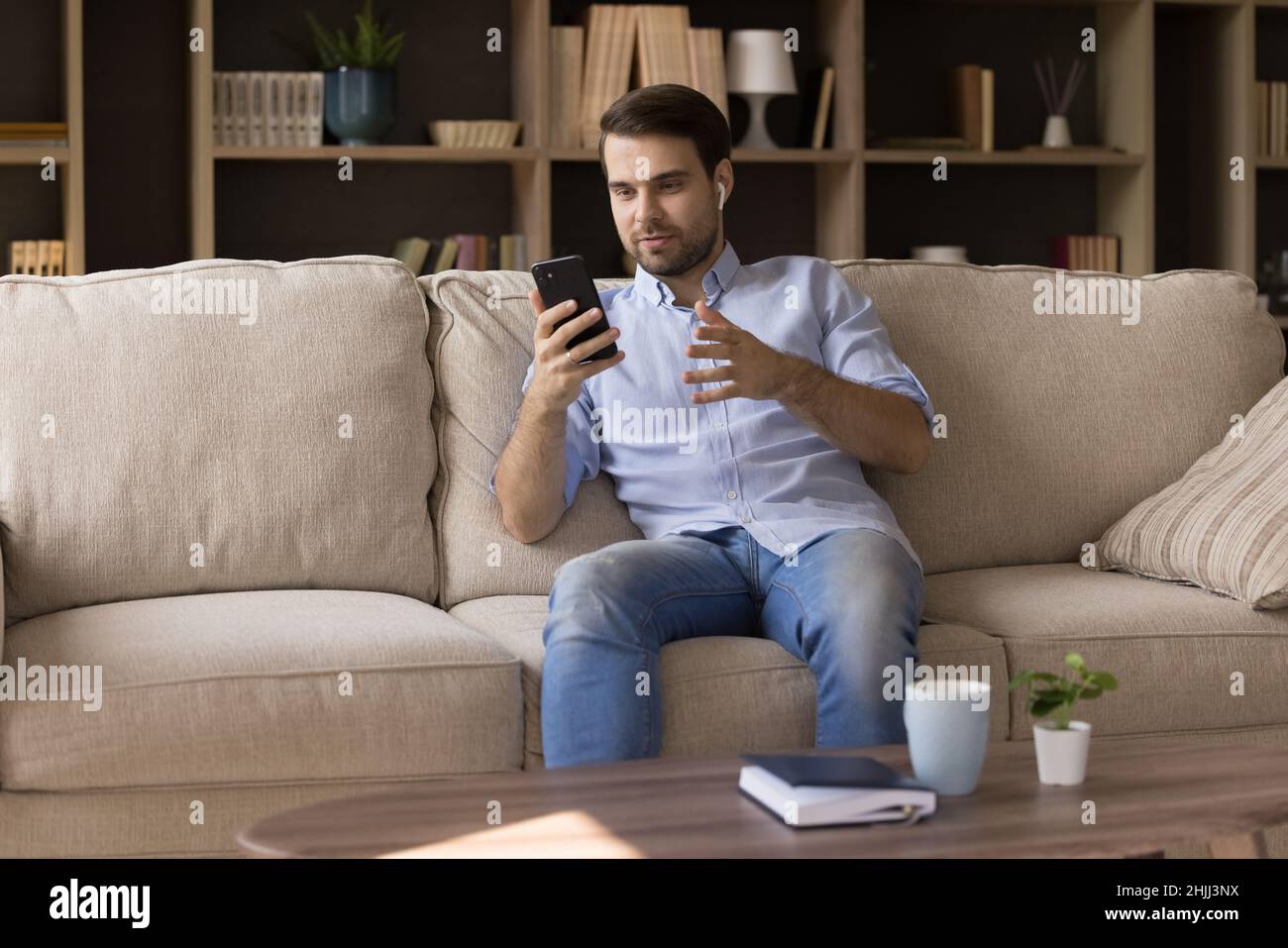 Happy relaxed young man holding video call. Stock Photo