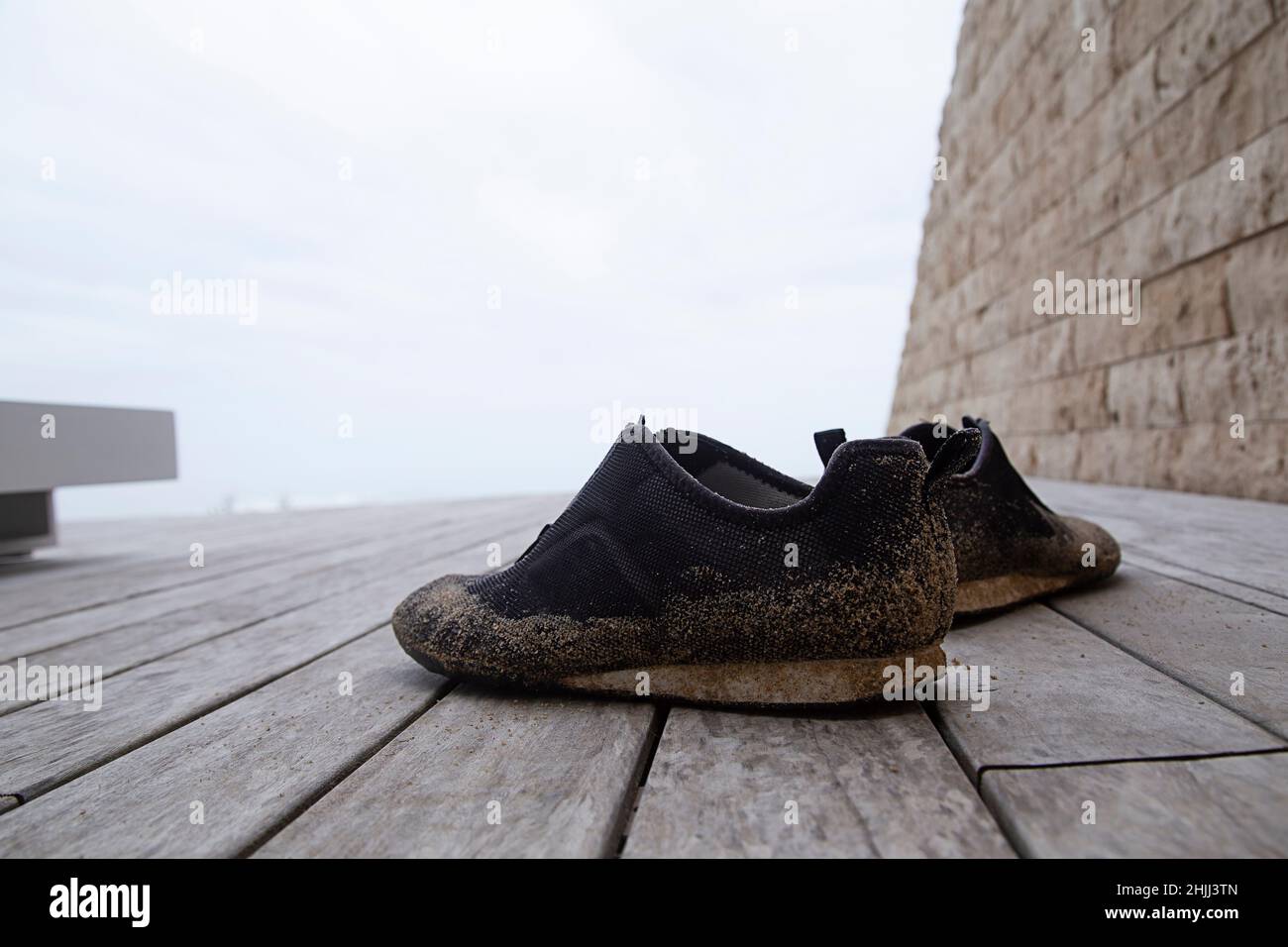 Sandy Beach Shoes on a deck at a beach house Stock Photo