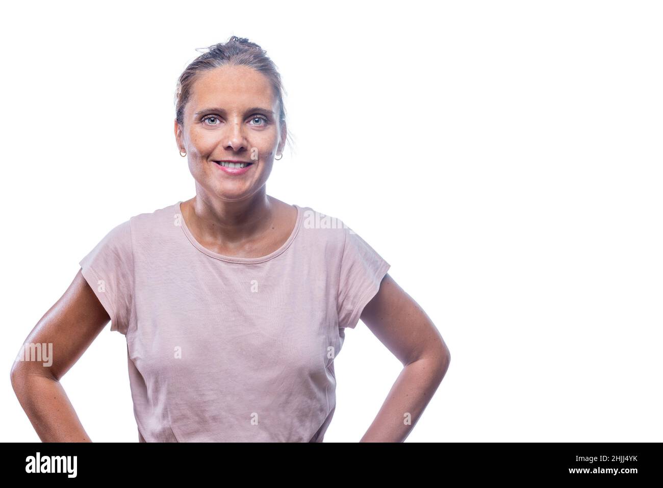 An adult woman with hands on waist looking at camera Stock Photo