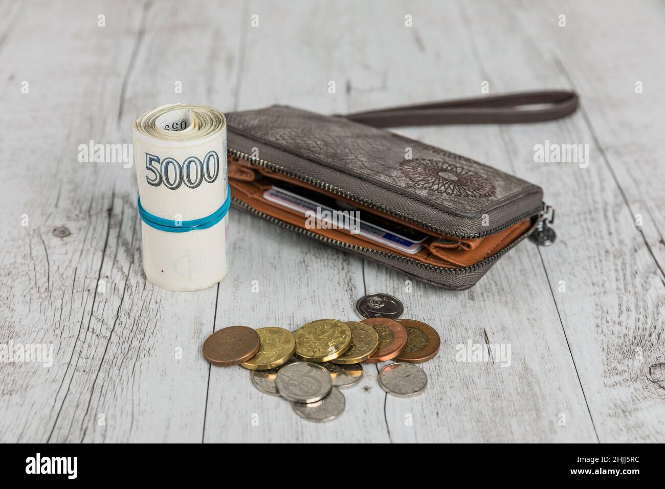 Czech banknotes rolled into a roll on a table with coins and a wallet. Banking concept.. Financial concept in Czech currency. business, finance, savin Stock Photo