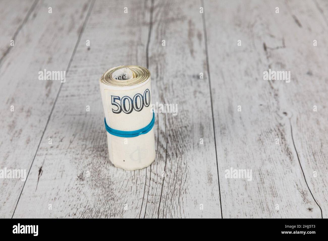 Czech banknotes rolled into a roll on a table. Banking concept.. Financial concept in Czech currency. business, finance, saving and cash concept. Stock Photo