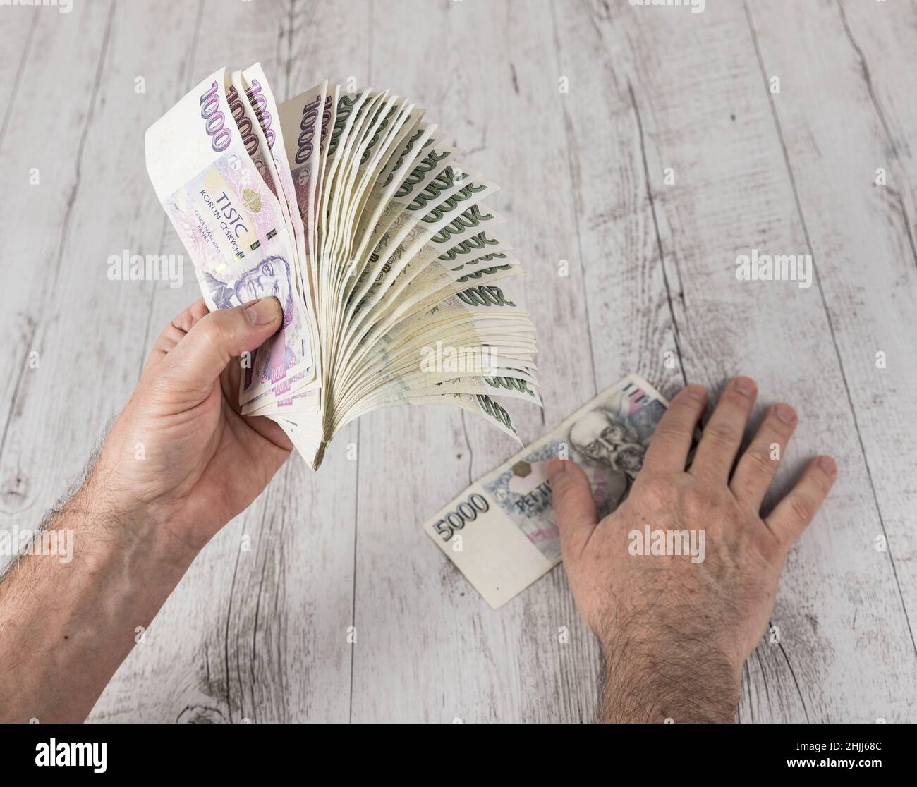 Czech banknotes in a fan in the hands of a trader. Financial concept.Financial concept in Czech currency. business, finance, saving and cash concept - Stock Photo