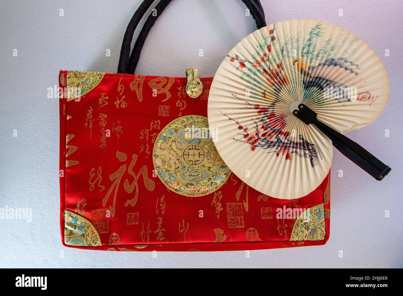 traditional asian silk bag with paper fan Stock Photo