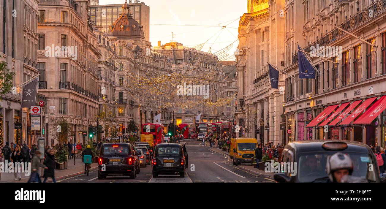 View of red buses and taxis on Regent Street at Christmas, London, England, United Kingdom, Europe Stock Photo
