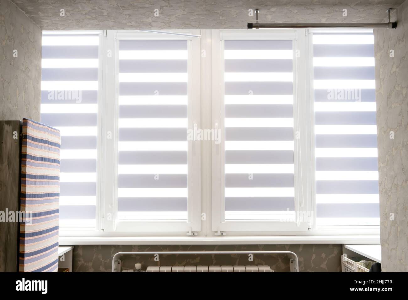 Windows with open modern horizontal blinds indoors, closeup. Stock Photo