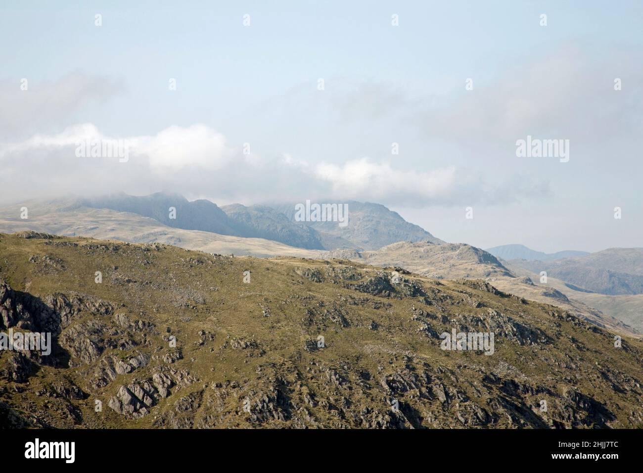 Bowfell and Crinkle Crags viewed from the summit ridge leading from the Old Man of Coniston to Swirlhow near Coniston the Lake District Cumbria Stock Photo