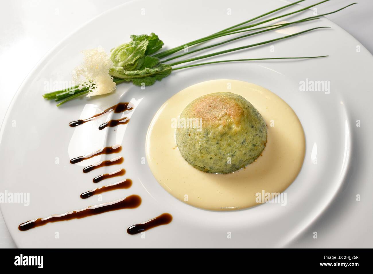 Vegetable flan with fondue fontina cheese in white plate with herb, Italian food recipes Stock Photo