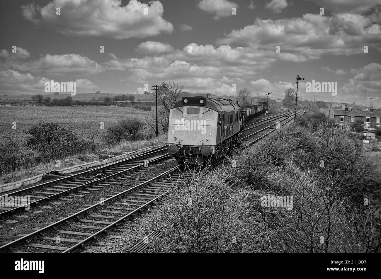 Coal train from Newmarket Colliery branch line pulled by a British Rail Class 25 joins the main line at Lofthouse Junction near Methley in 1979 Stock Photo