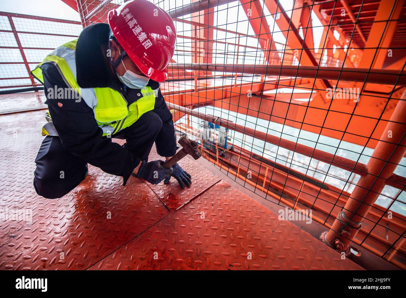 Liupanshui. 29th Jan, 2022. A worker carries out maintenance tasks on the Beipanjiang Bridge in southwest China's Guizhou Province, Jan. 29, 2022. Sitting over 565.4 meters above a valley, the Beipanjiang Bridge has been certified as the world's highest bridge by the Guinness World Records. Spanning 1,341.4 meters, the bridge links Duge Township of Liupanshui in southwest China's Guizhou with Puli Township of Xuanwei in southwest China's Yunnan Province. Credit: Tao Liang/Xinhua/Alamy Live News Stock Photo
