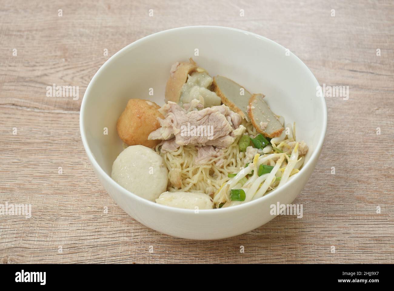 dry egg yellow noodles noodles topping slice boiled pork and ball on