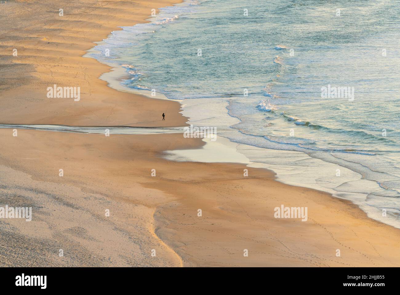 One person alone on a beach Stock Photo
