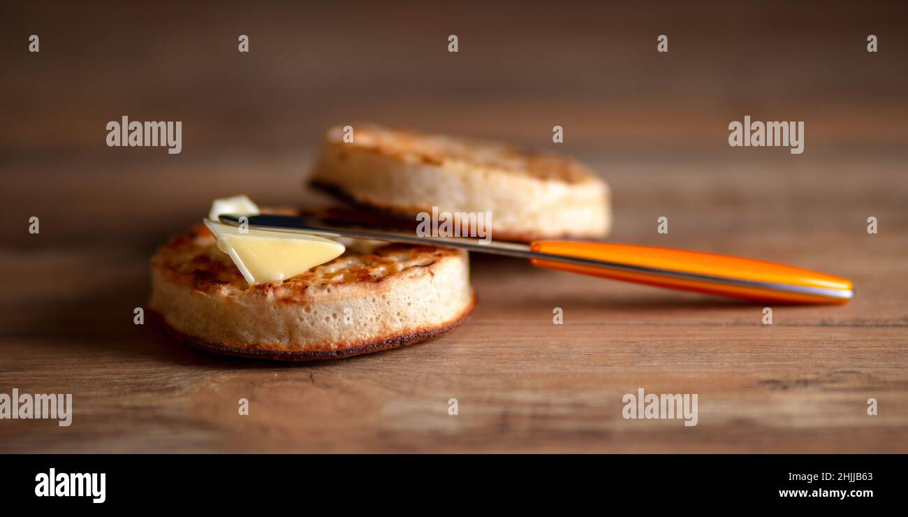 Hot buttered Crumpets a traditional British tea time treat Stock Photo