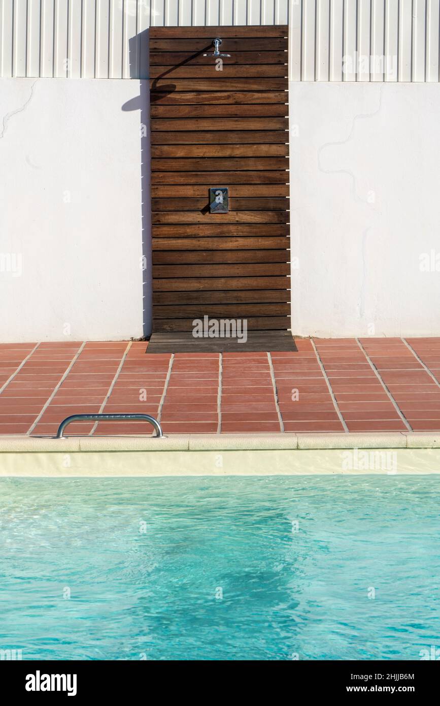 Outdoor shower set next to a swimming pool Stock Photo