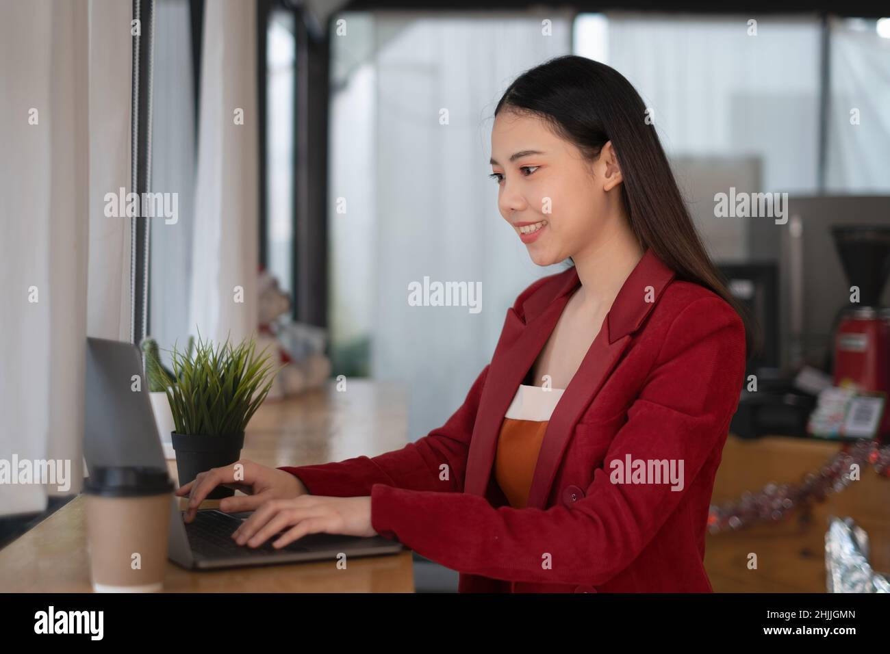 Woman Using Computer And Digital Technology A business woman using laptop computer to cyber security for her saving ...