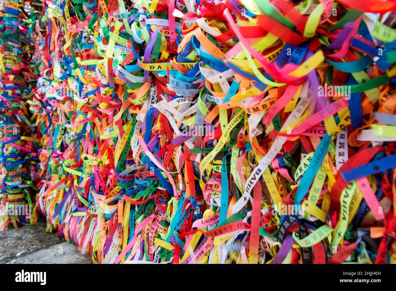 Thousands of colored ribbons tied to a gate. Salvador, Bahia, Brazil. Stock Photo