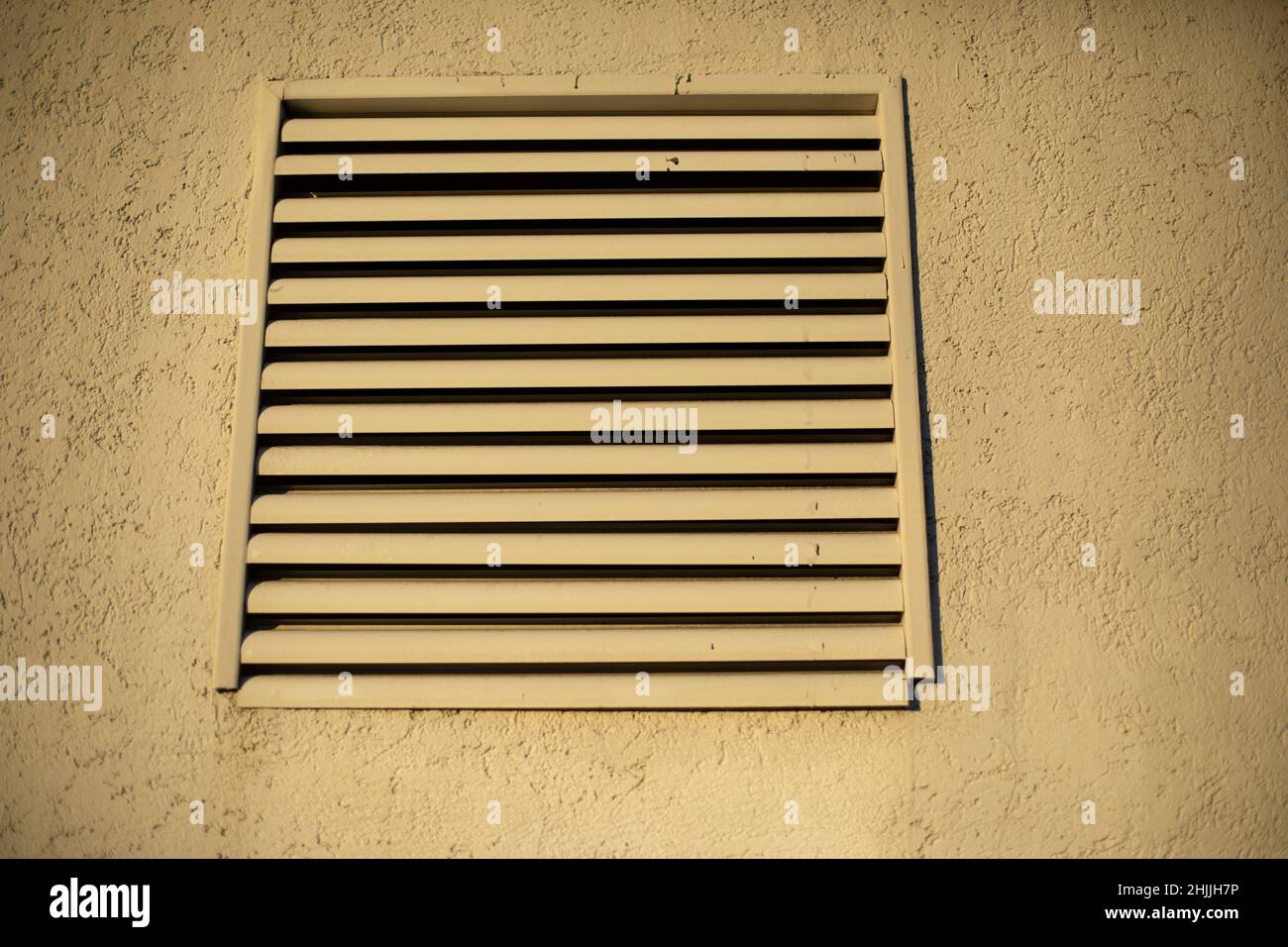 Ventilation outside building. Grille on building. Communications for air flow. Stock Photo