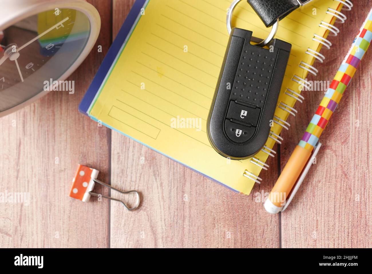 notepad, clock and car key on table  Stock Photo