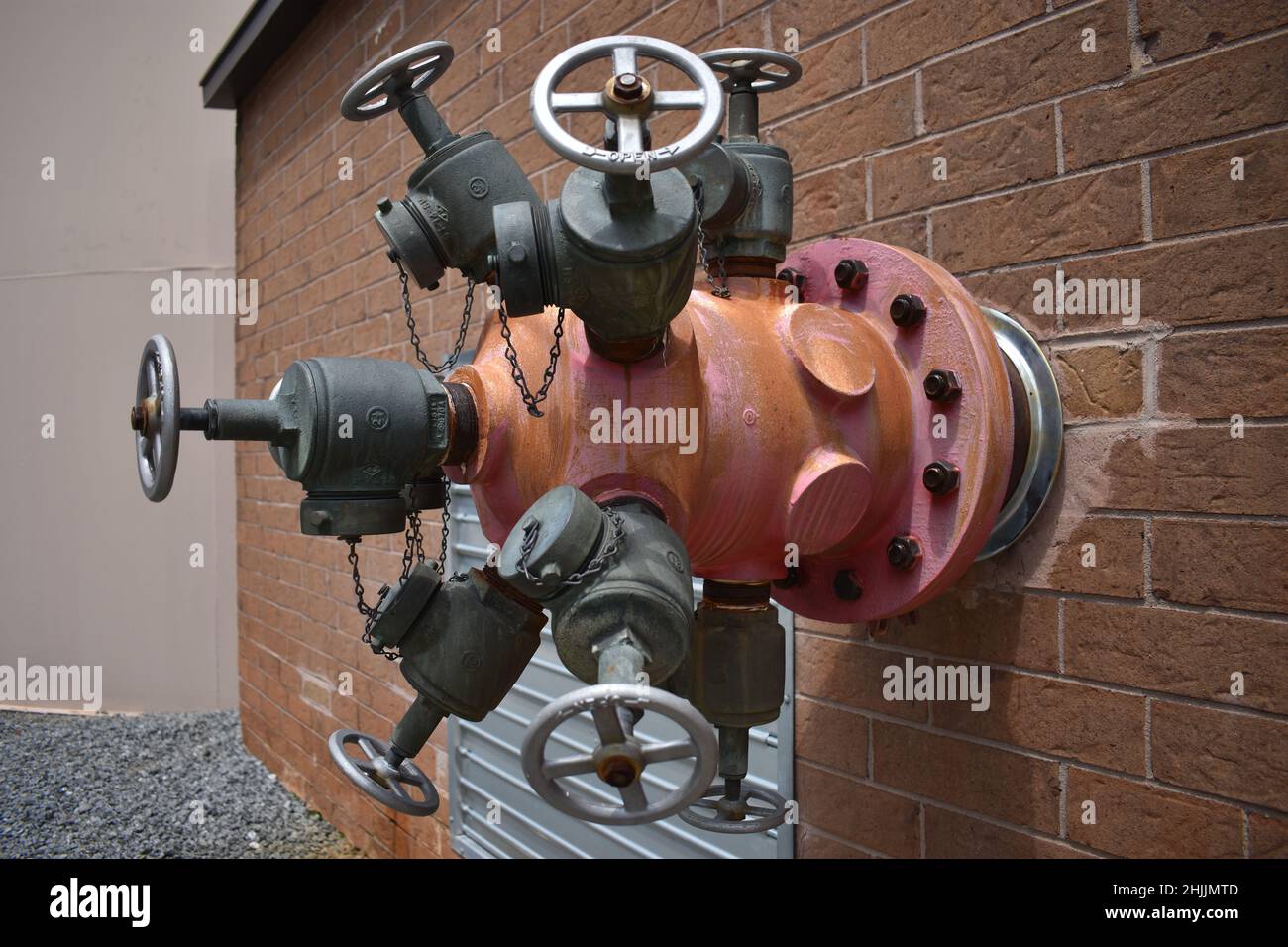 Closeup shot of some gate valves stuck on a brick wall Stock Photo Alamy