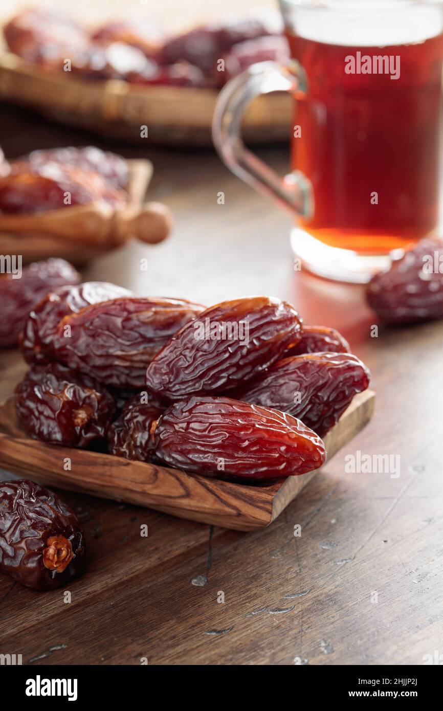 Tea and dried dates on a old wooden table Stock Photo - Alamy