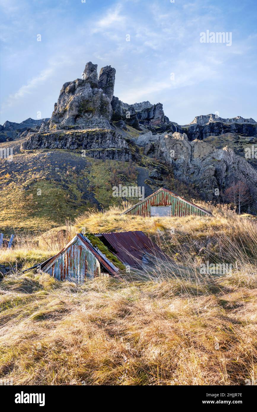 Farm buildings and outhouses built into the hillside in southern Iceland. These turf houses are traditional and built to insuralte against the cold ha Stock Photo