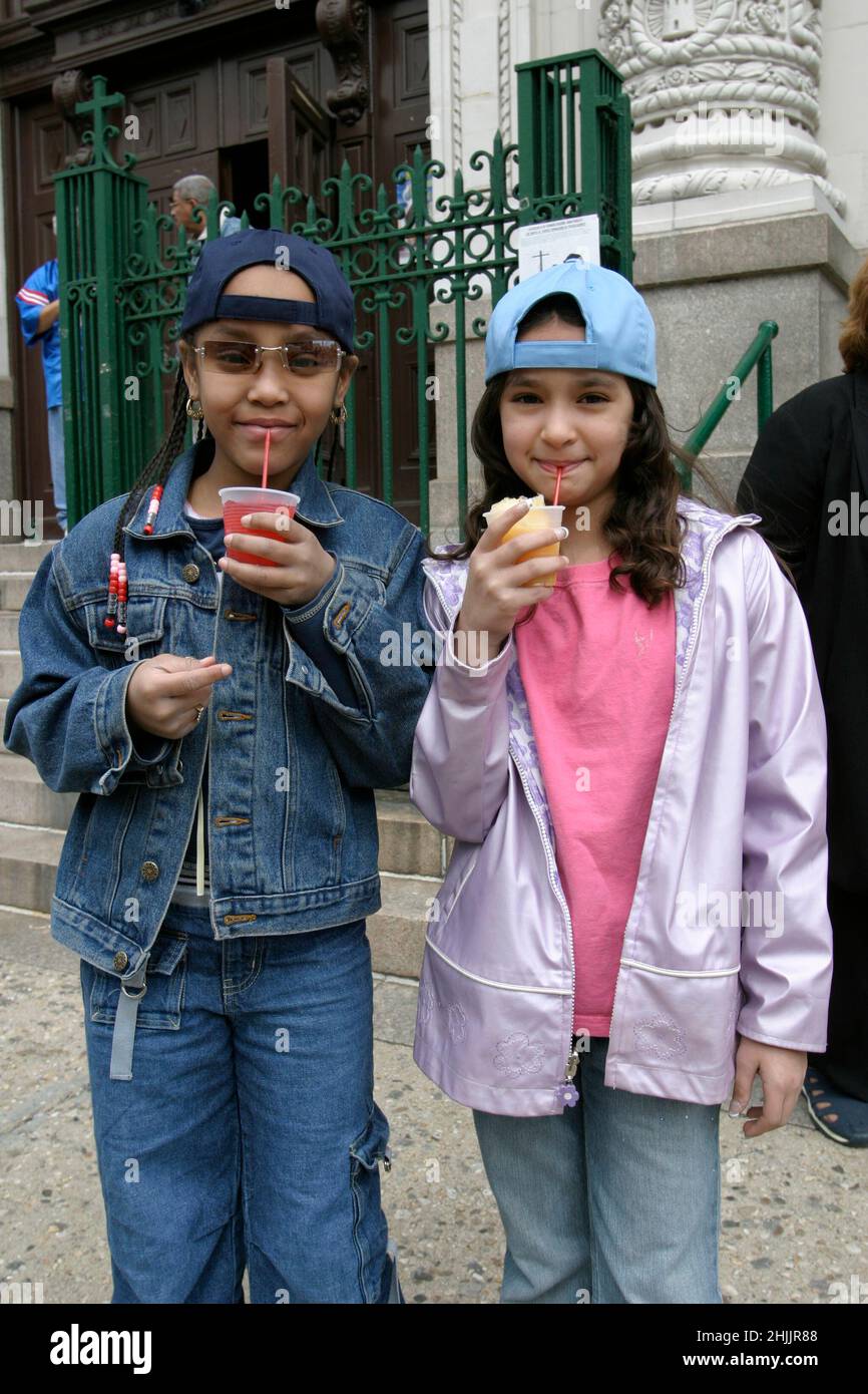 Young friends having 'ices' on the street in Bushwick, Brooklyn, a neighborhood in New York City. Stock Photo