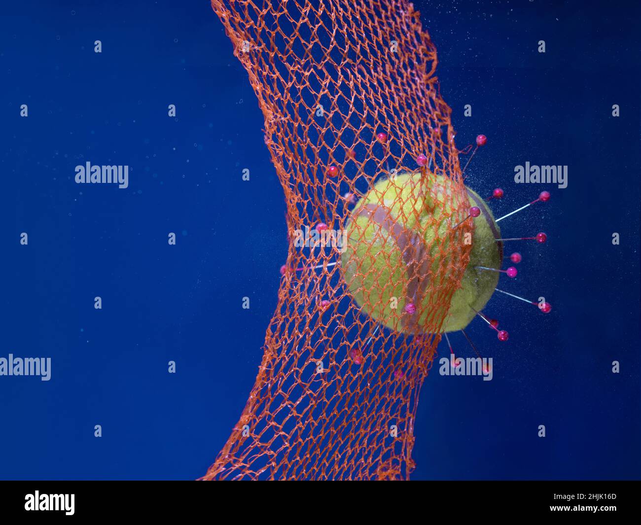 Conceptual Covid  virus being stopped by a barrier Stock Photo