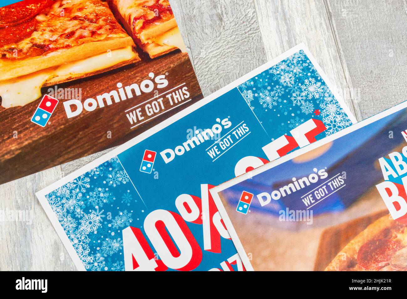 UK Domino's Pizza direct marketing leaflets from mailbox drop and featuring Domino's logo. For Covid takeaway food ordering. Stock Photo