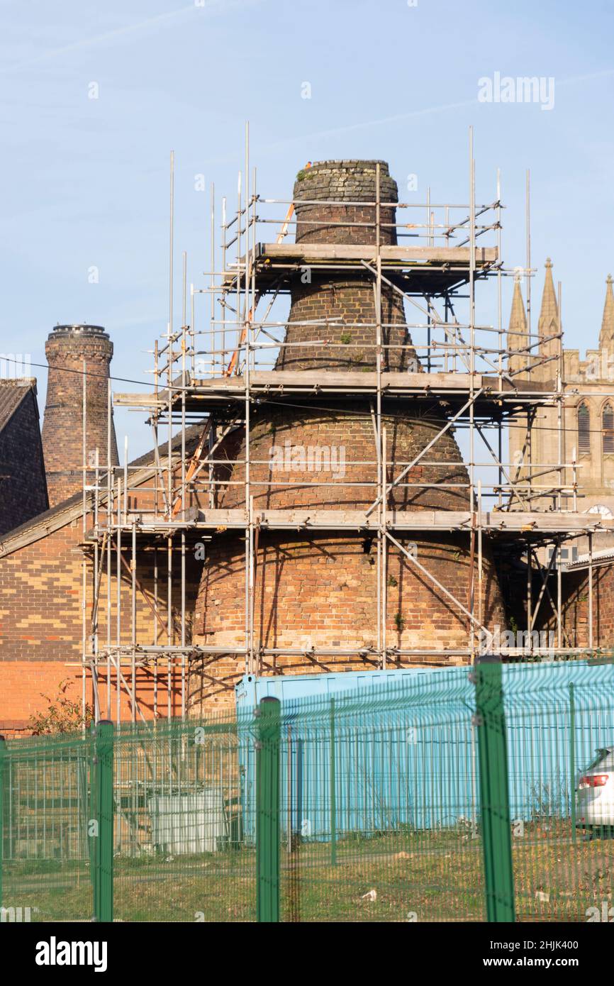 traditional victorian ceramic pottery factory kiln chimney with scaffolding in Longton Stoke on