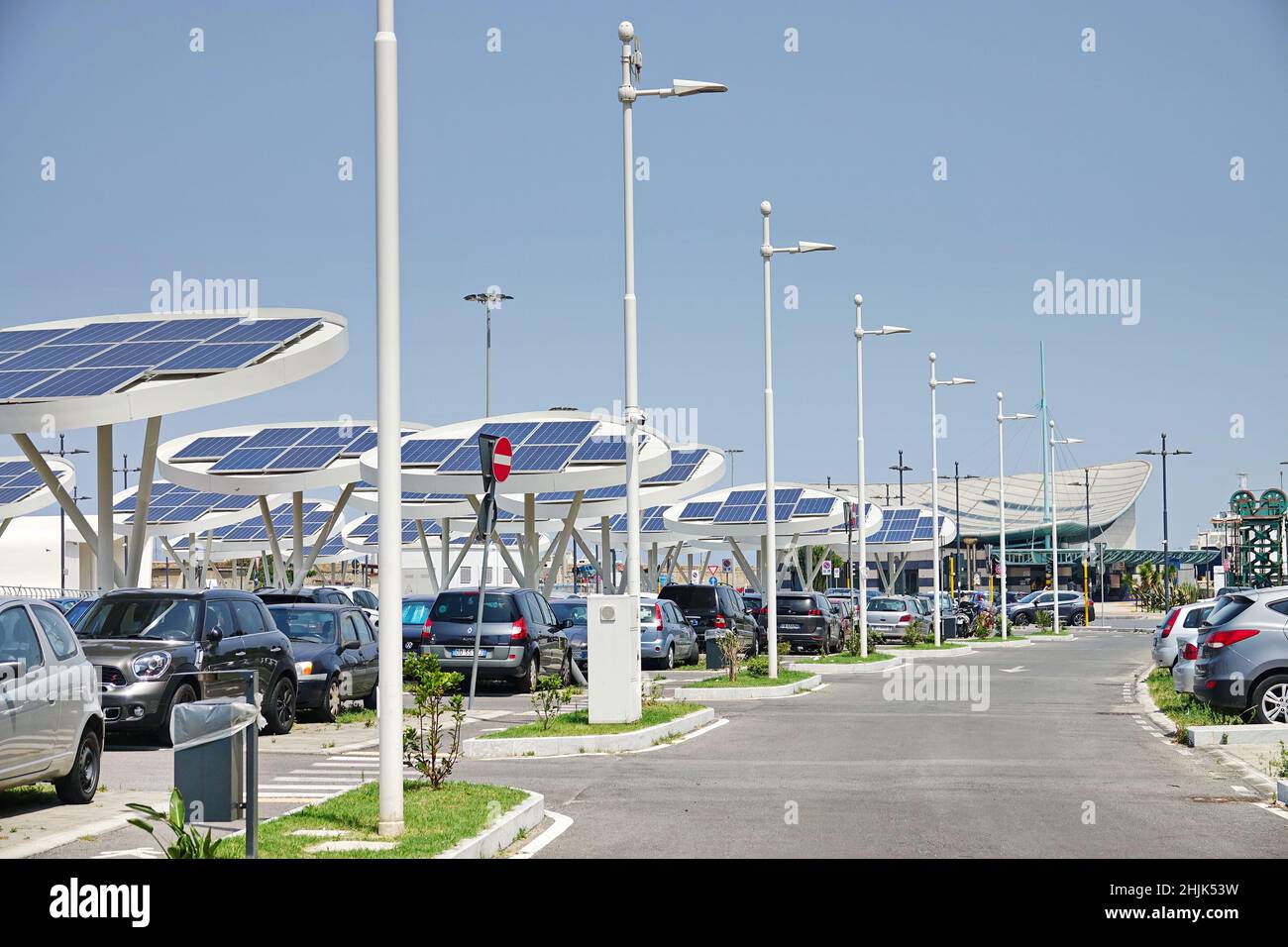 Solar panels in a car park. Companies are installing renewable energy sources to reduce their carbon footprint.  Reggio Calabria, Italy - July 2021 Stock Photo