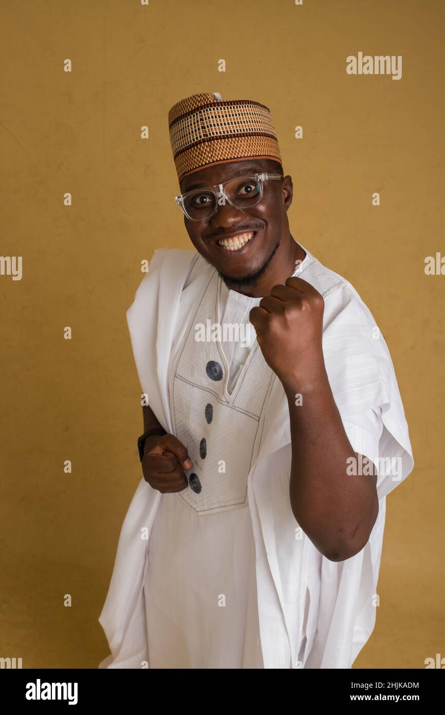 A Traditionally Dressed Northern Business Man in Glasses Fist Pump the Air Stock Photo