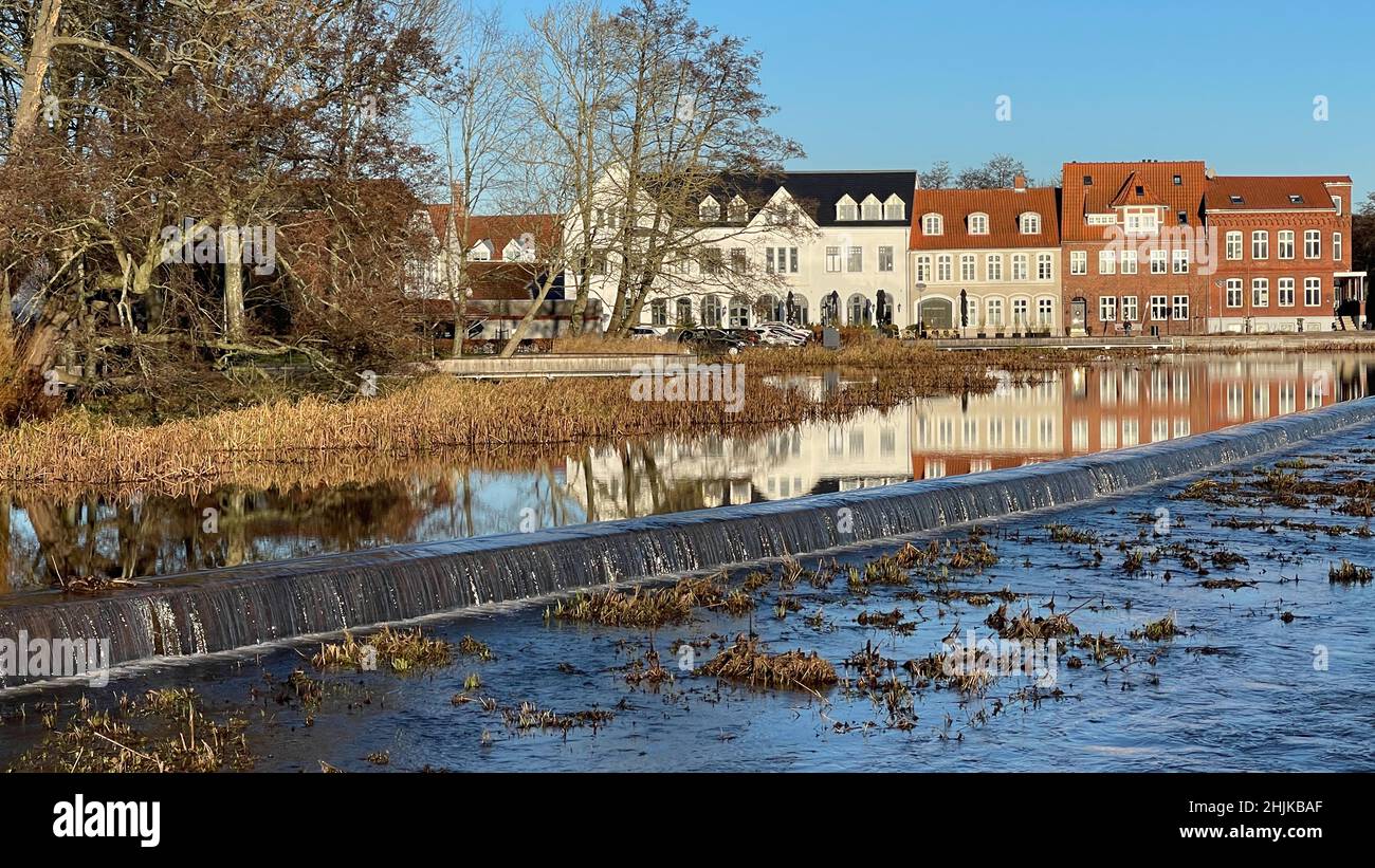 Slow travel Denmark: Buildings in the old part of Tønder are reflected in the surface of the river Vidå Stock Photo