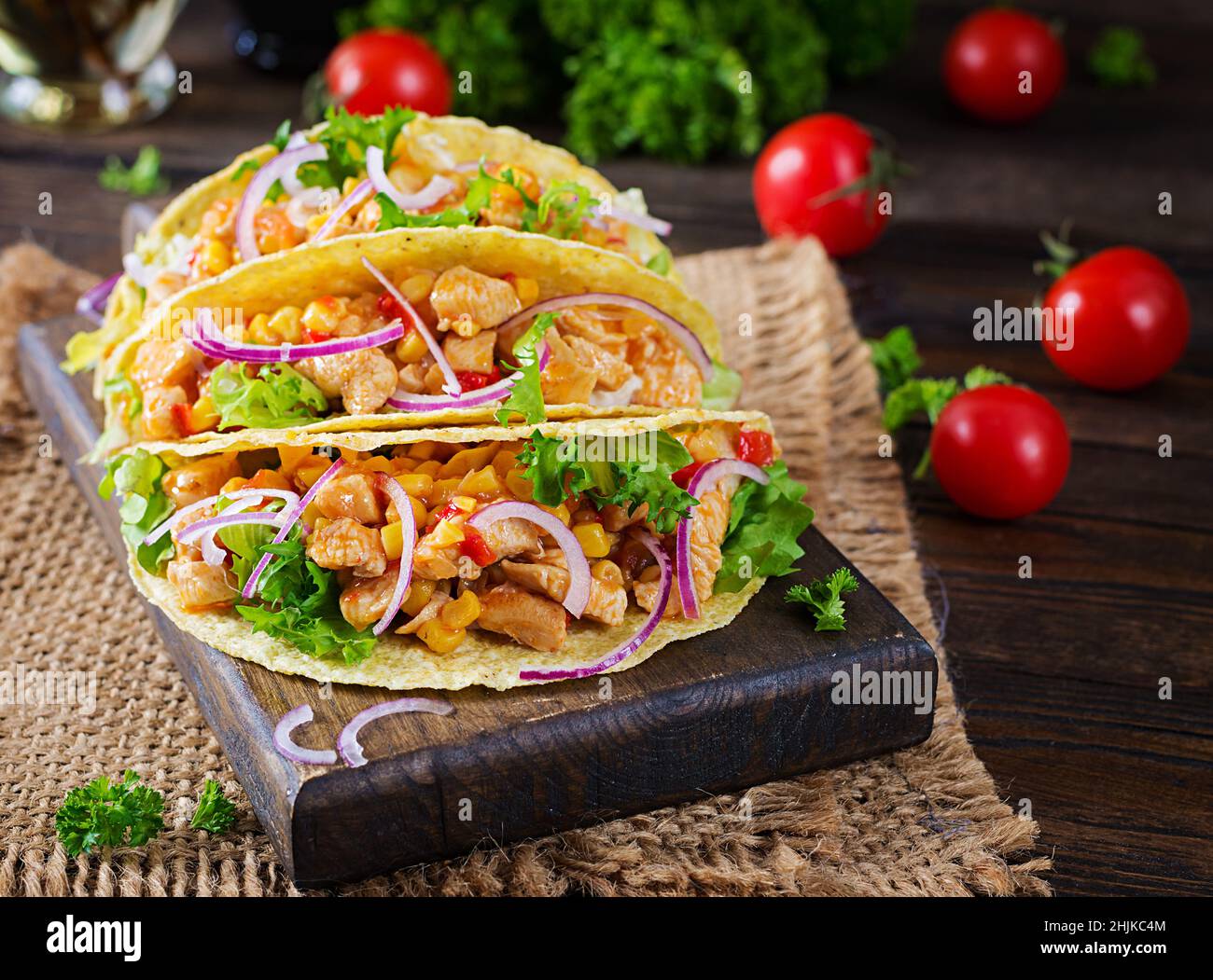 Mexican tacos with chicken meat, vegetables and red onion. Mexican taco