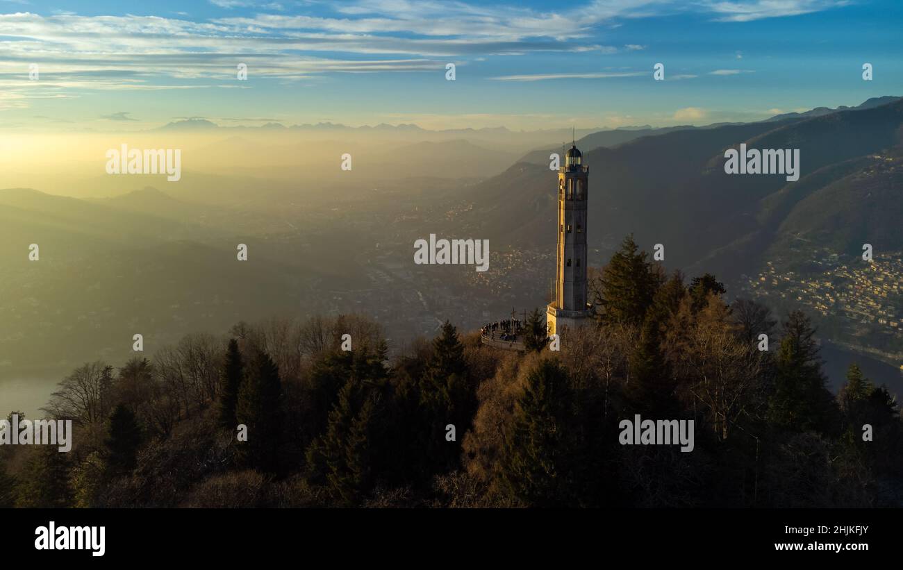 Aerial drone view of a lighthouse over Lake Como skyline with