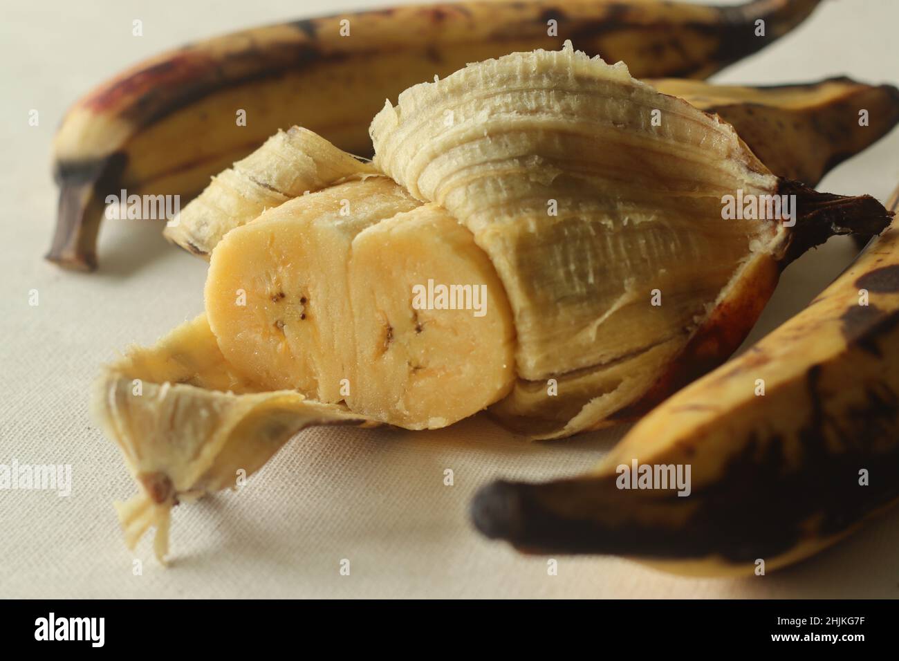 Twin Ripe plantain yellow in colour, ready to eat with skin half peeled