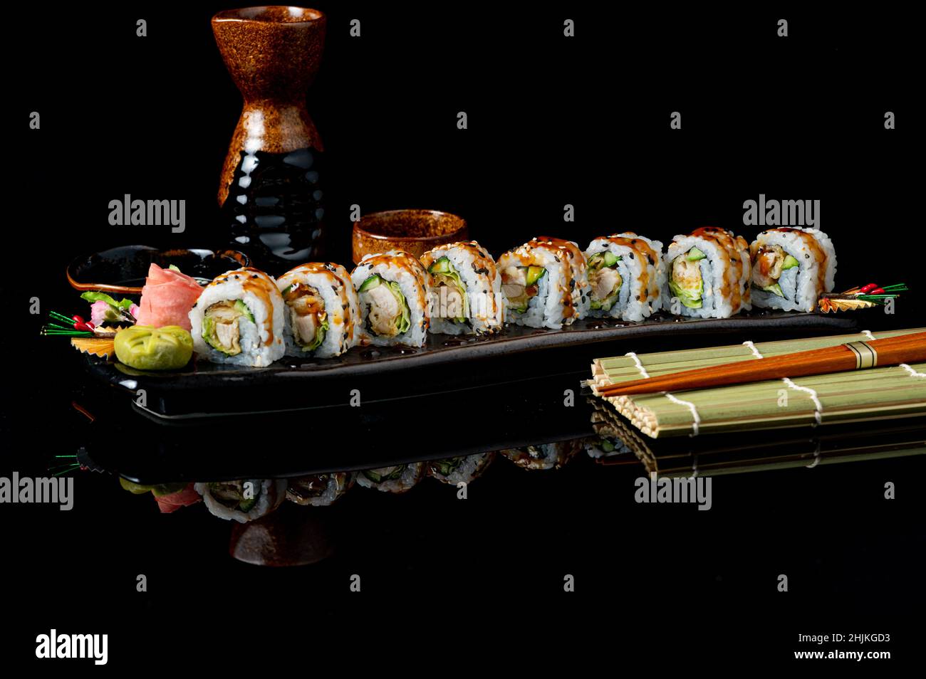 Serving of tori katsu rolls with tempura and chicken on a black