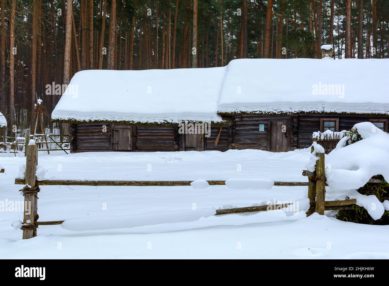 Old wooden log house covered with snow Stock Photo