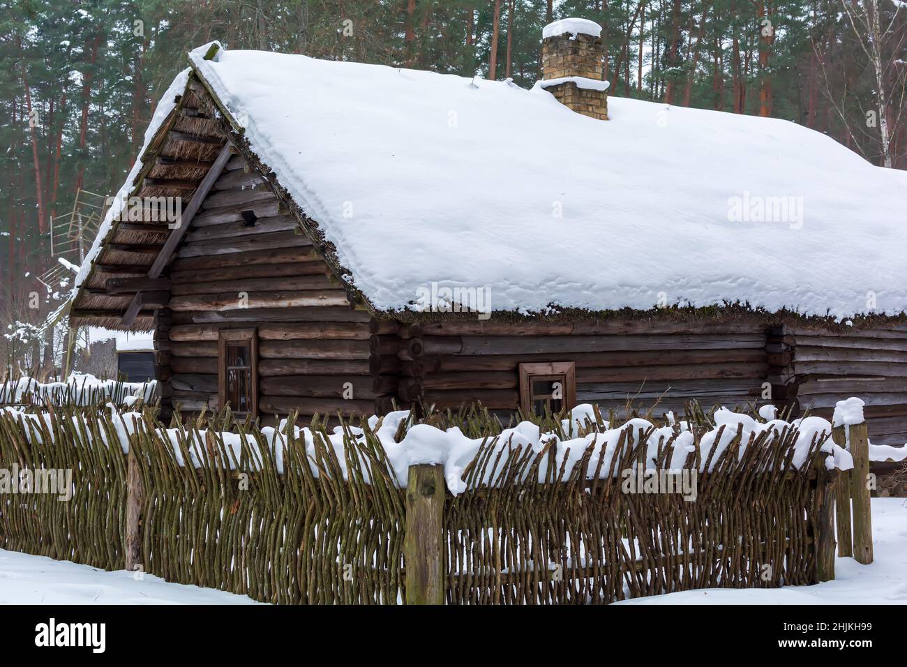 Old wooden log house covered with snow Stock Photo