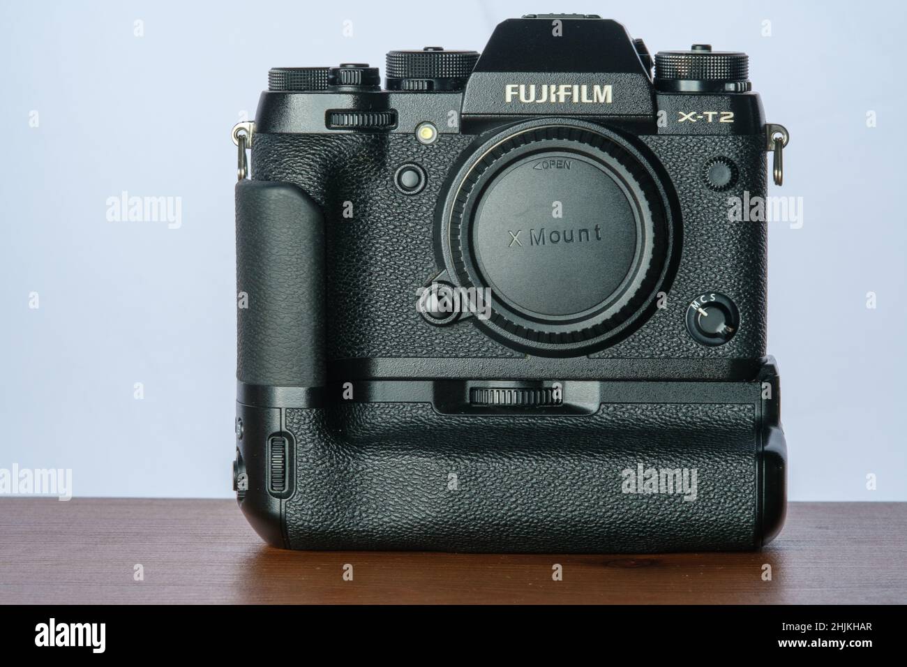 View of the mirrorless Fuji film aps-c camera with a battery grip on Stock Photo