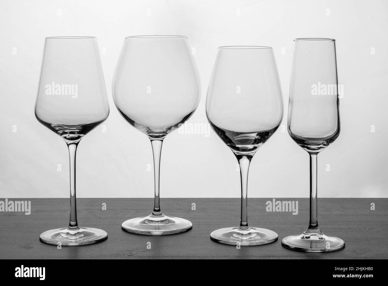 A set of various wine and champagne glasses in black and white Stock