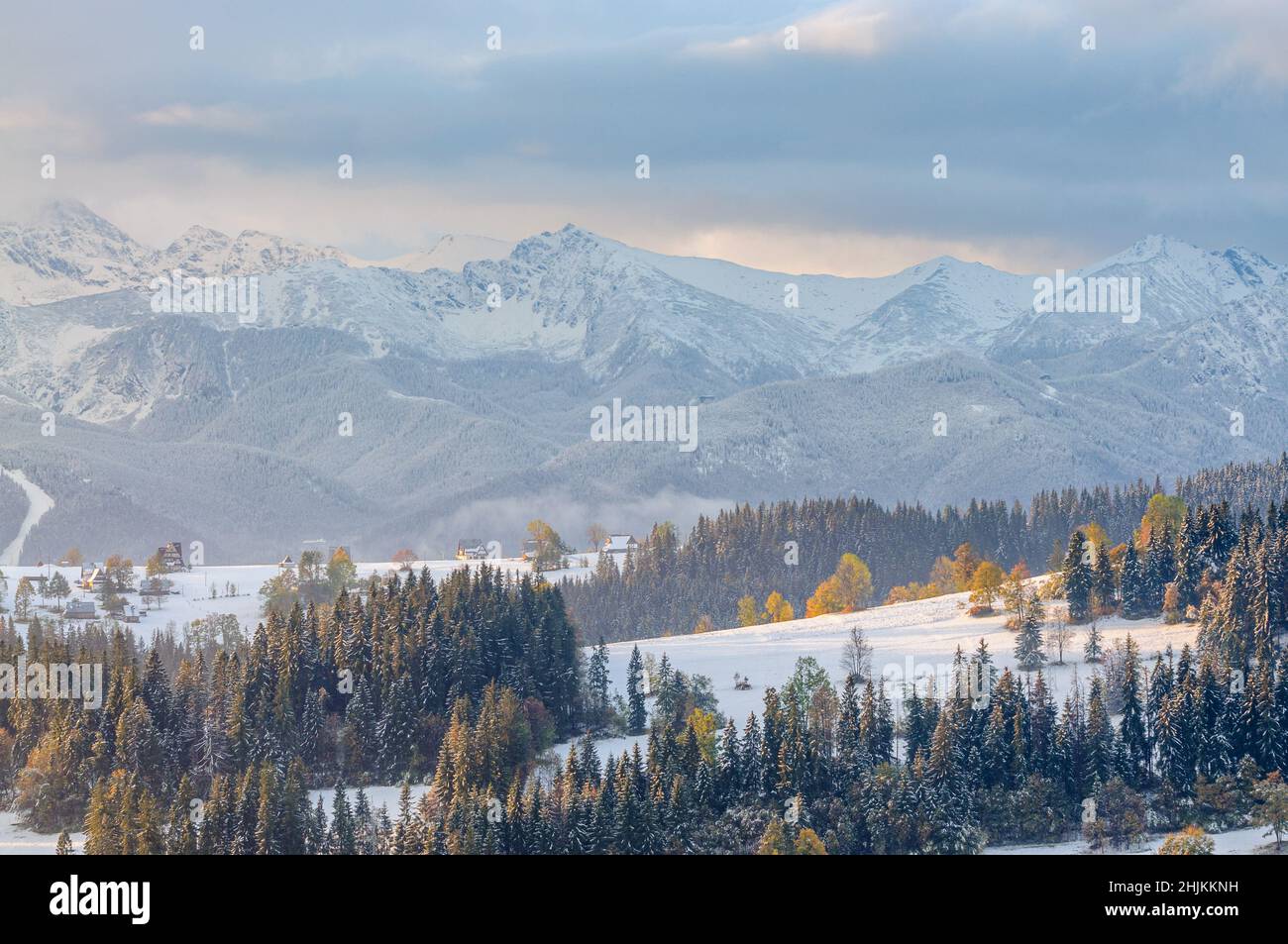 The first snow in Podhale. In the background snowy peaks of the Tatra Mountains (Swinica, Kasprowy Wierch and the Western Tatras). Stock Photo