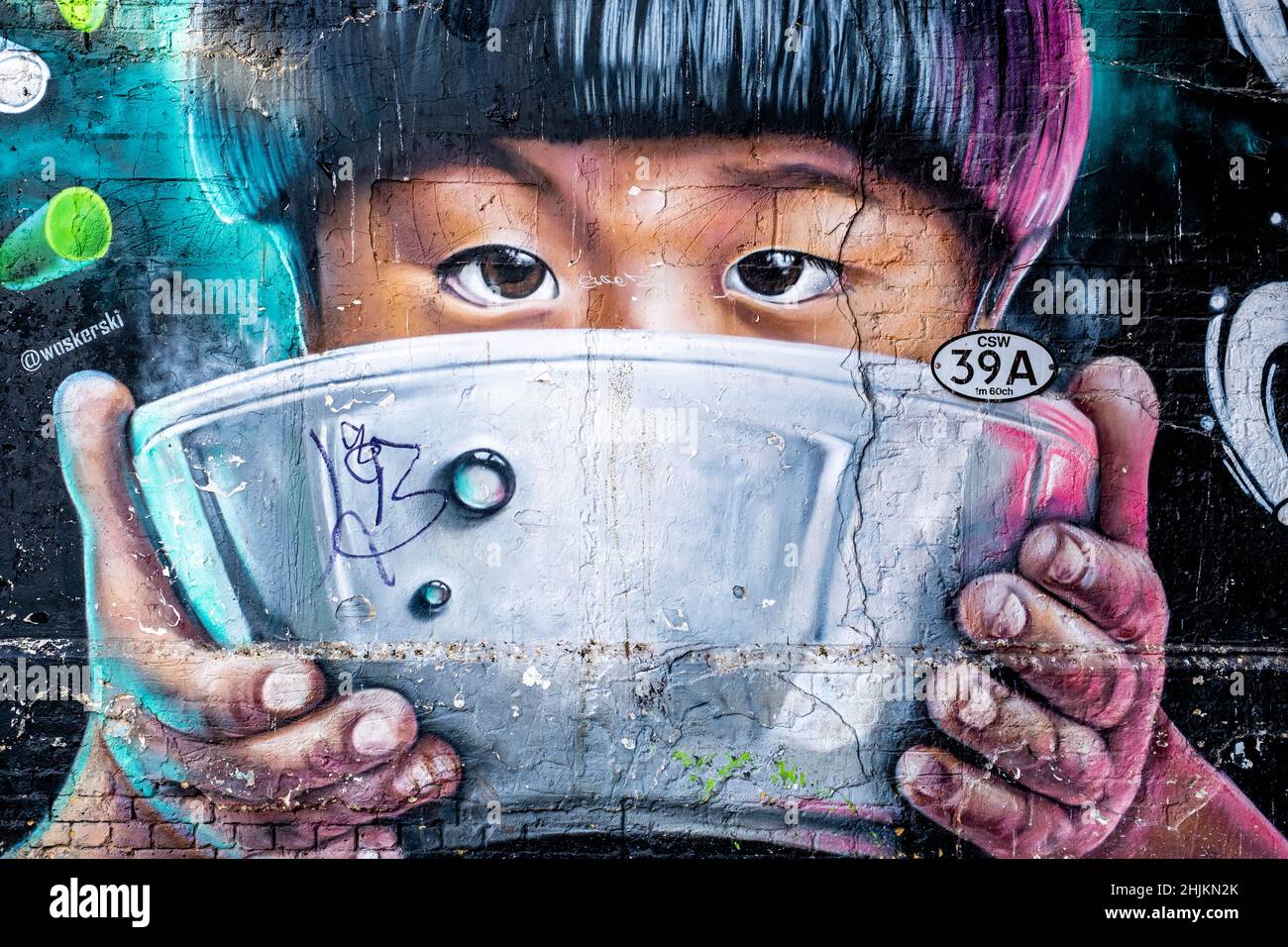 London England UK, 29 January 2022, Wall Art Or Graffiti Of Asian Child Drinking From A Soup Bowl Outside Wagamama Restaurant Bankside London Stock Photo