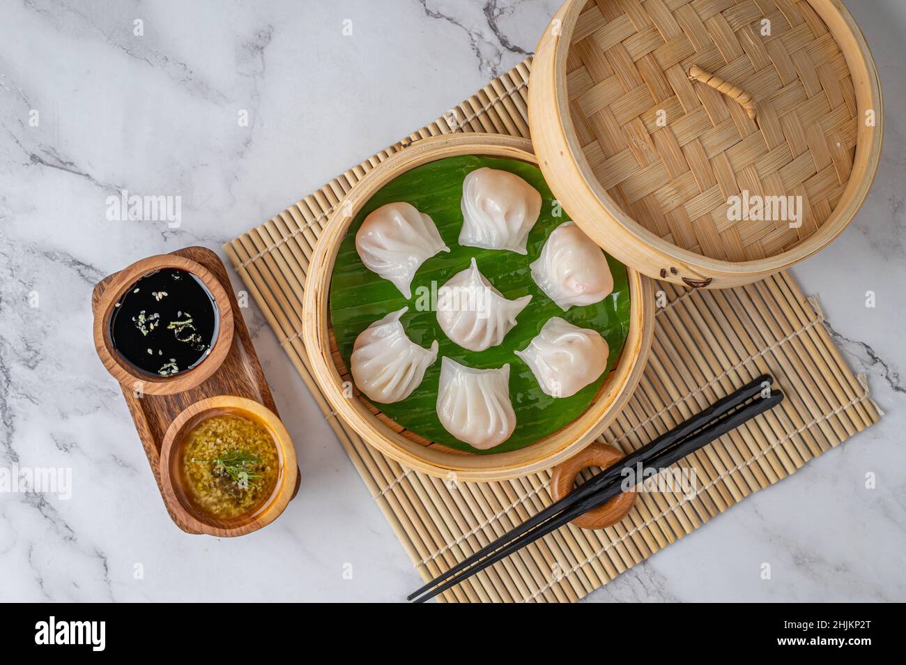 Serving of dim sum (Japanese dumplings) with sauce and chopsticks Stock ...
