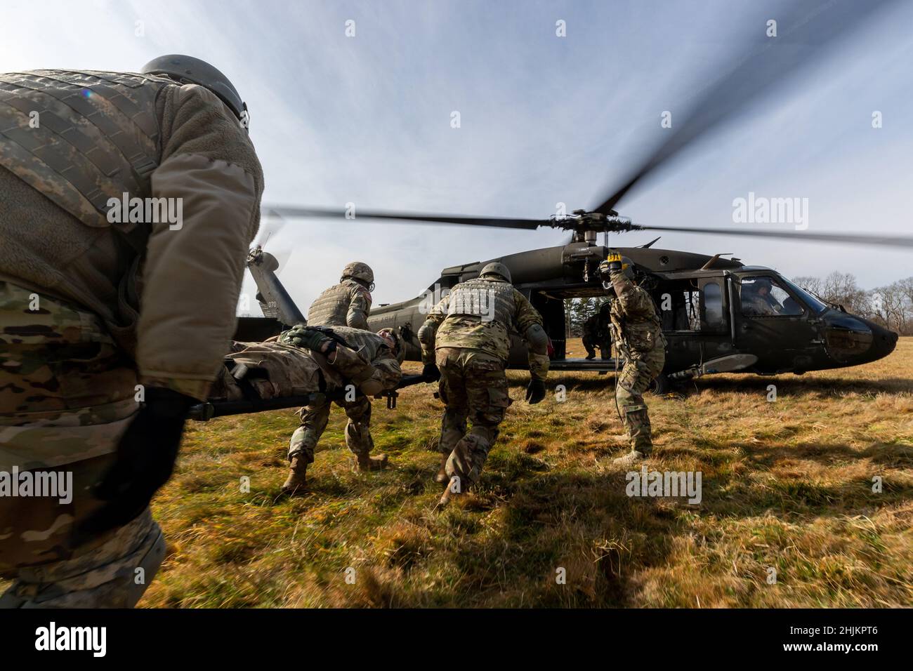 U.S. Army combat medics carry a simulated patient to a UH-60 Black Hawk ...