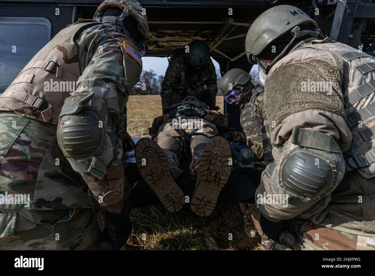 U.S. Army combat medics carry a simulated patient to a UH-60 Black Hawk ...