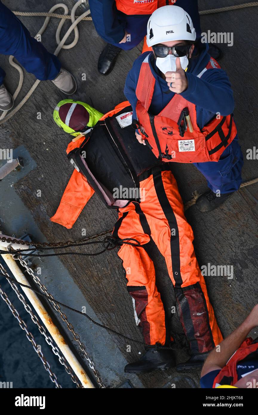 USCGC Thetis (WMEC 910) crew members haul a training dummy aboard the