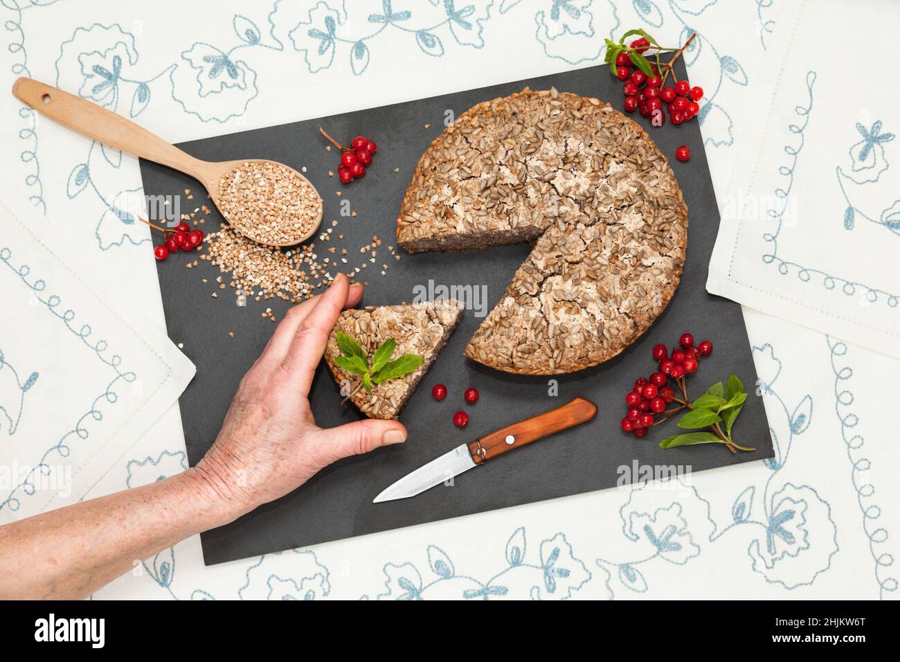 Homemade dietary buckwheat bread with grandmother hand Stock Photo